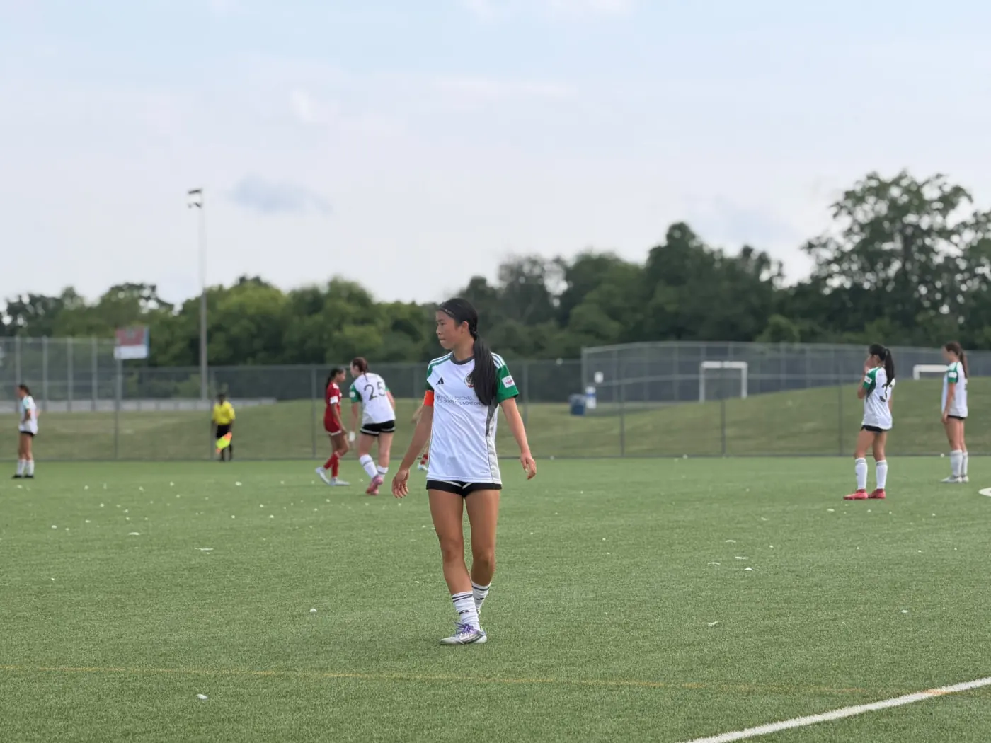 Angelina wearing a captain's armband on the field