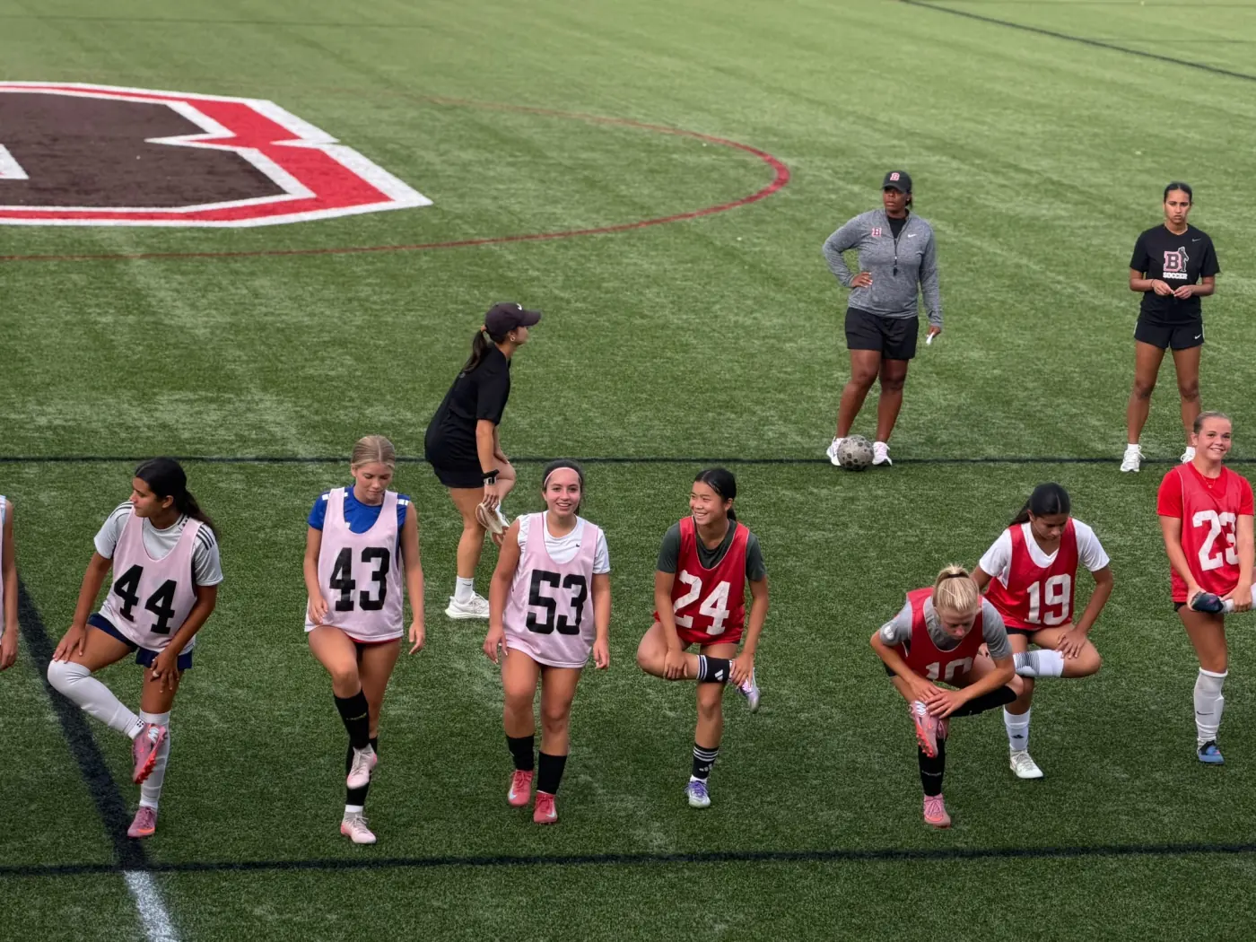 Angelina warming up with other players at a college ID camp