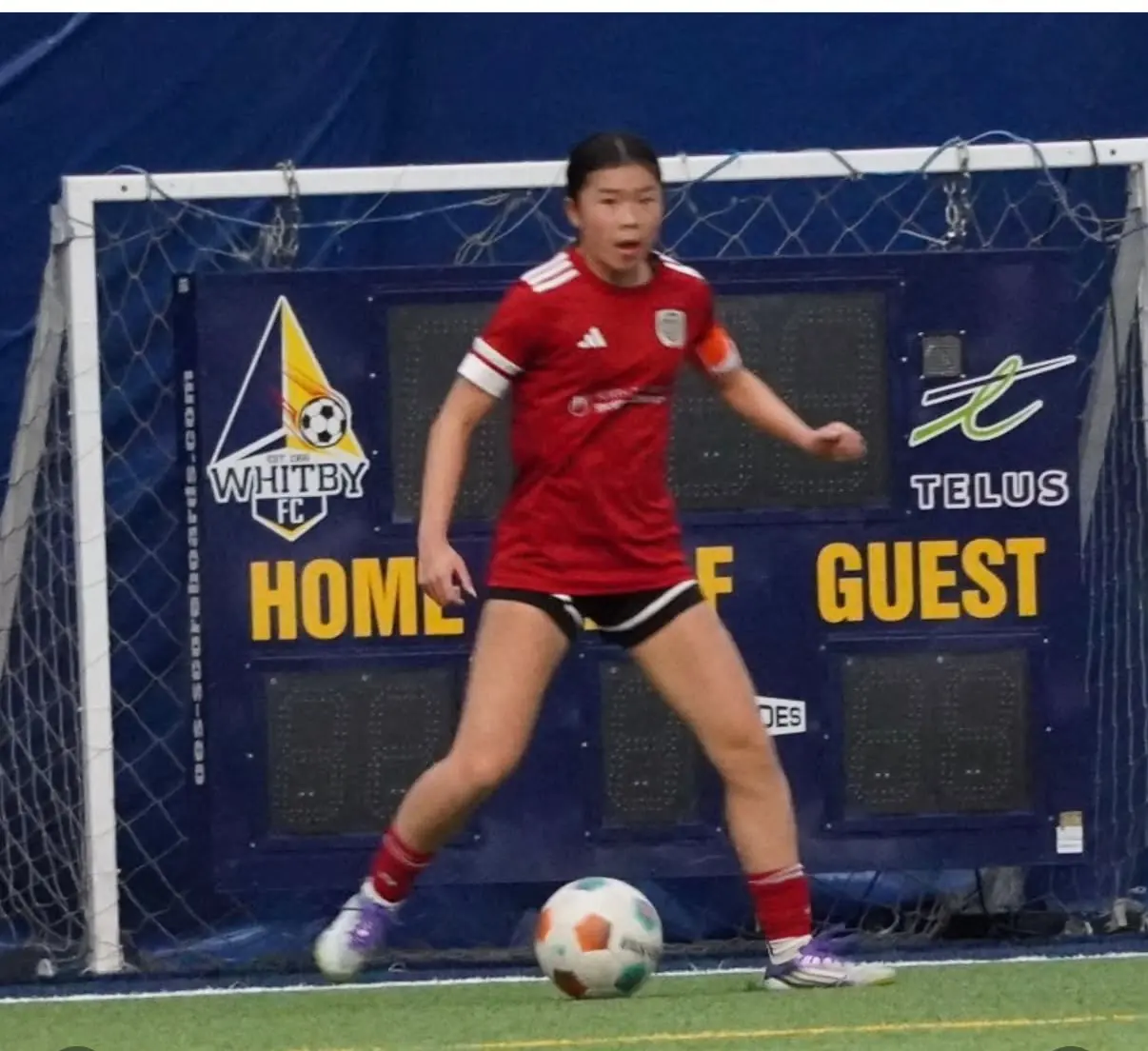 Angelina controlling the ball during an indoor match