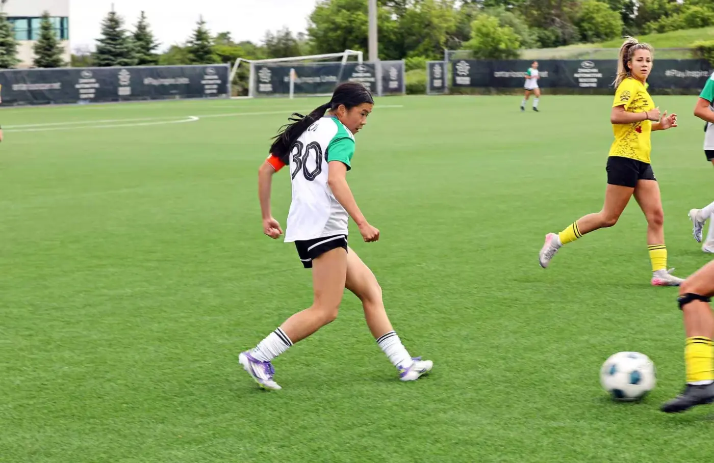 Angelina passing the ball during a match