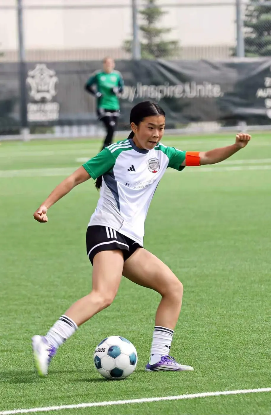 Angelina striking the ball during a match