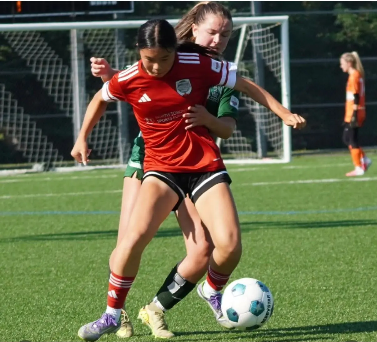 Angelina shielding the ball from an opponent