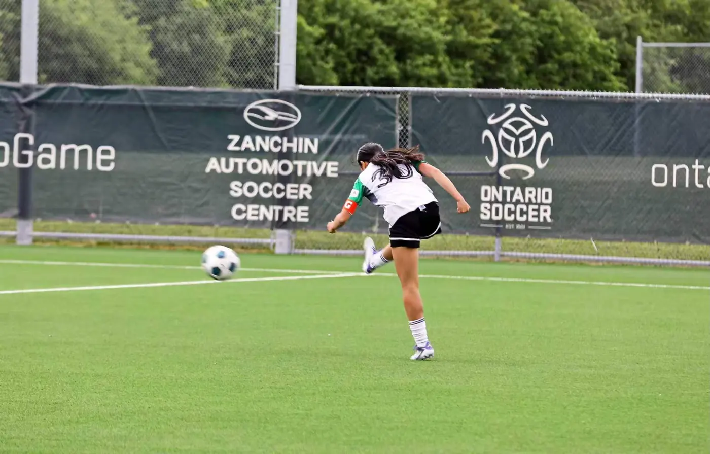 Angelina taking a shot during a soccer match