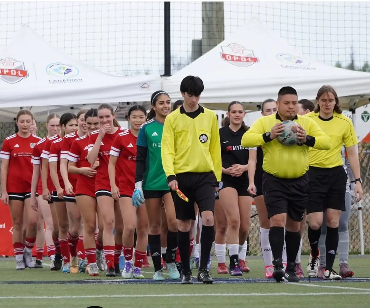 Angelina walking onto the field with her team before a match