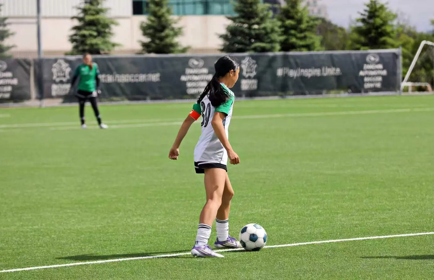 Angelina controlling the ball near the touchline